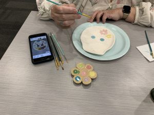 A participant paints her egg