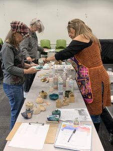 Alex is pouring paint colors for participants