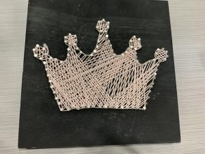 Crown made of string on a board