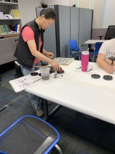 Instructor Brenda working with art materials