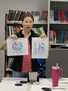 Black ink painting samples shown by the instructor