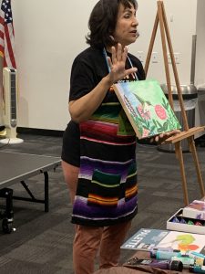 Alma shows students what they will be painting today