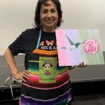 Alma holding her finished canvas