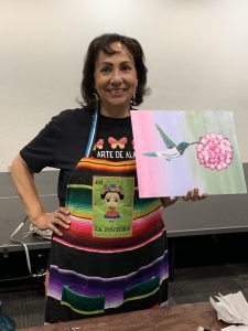 Alma holding her finished canvas