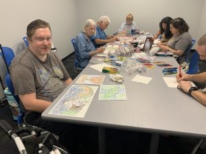 Coloring club members work on their creations