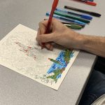 Coloring club members work on their creations