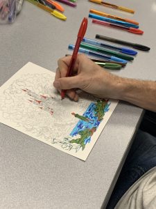 Coloring club members work on their creations