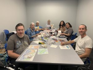 Coloring club members work on their creations